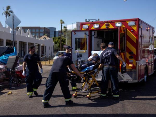 Firefighter EMT perso<em></em>nnel assist a man who collapsed during a 27 days long heat wave with temperatures over 110°F (43°C), near downtown Phoenix, Arizona, on July 26, 2023.