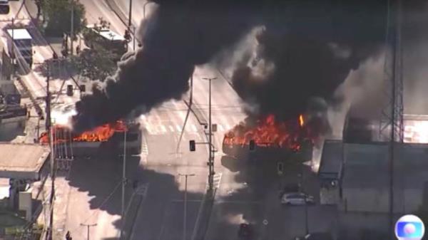 An aerial views shows buses in fire in the middle of roads, in Rio de Janeiro, Brazil, October 23, 2023, in this screen grab obtained from a video. TV GLOBO/via REUTERS