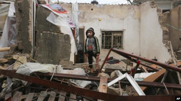 A Palestinian boy stands among the destruction after Israeli strikes on Rafah, Gaza Strip, Nov. 15, 2023.