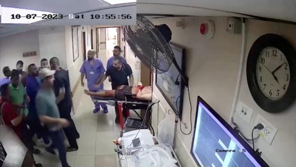 A screen grab of a video released by the Israeli army on Nov. 19, 2023 shows security camera footage of what they say were the Islamic militants of Hamas bringing in a hostage from Israel into the Shifa hospital on the day of the October 7 attack.