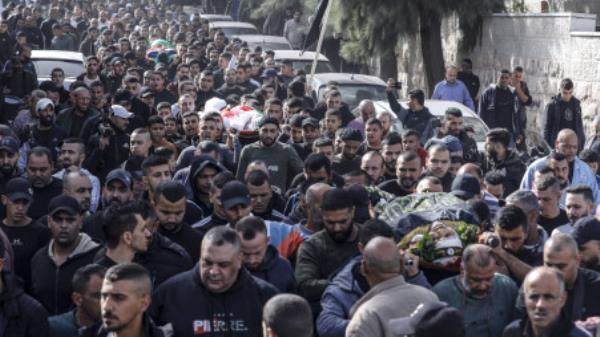 Mourners carry the bodies of three of five Palestinians killed in the occupied West Bank city of Jenin in an overnight Israeli incursion, during their funeral on November 26, 2023. Five people were killed by Israeli army fire in Jenin, the Palestinian health ministry said, during an incursion by a large number of armoured vehicles into the city, which was recently the scene of the deadliest Israeli raid in the West Bank in almost 20 years. Photo AFP