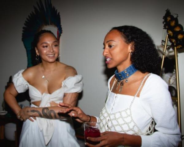 two women in white speaking