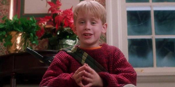 Macaulay Culkin sits at the top of the stares taunting the robbers in Home Alone