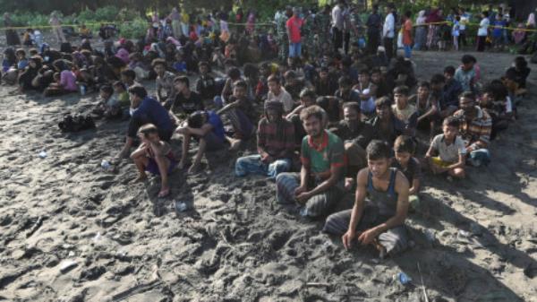 Rohingya Muslims rest on a beach after they land in Blang Raya, Pidie, Aceh province, Indonesia, December 10, 2023. REUTERS/Stringer

