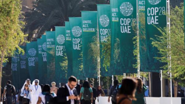 Delegates walk at the United Nations Climate Change Co<em></em>nference COP28 in Dubai, United Arab Emirates, December 8, 2023. REUTERS/Thaier Al Sudani/File Photo

